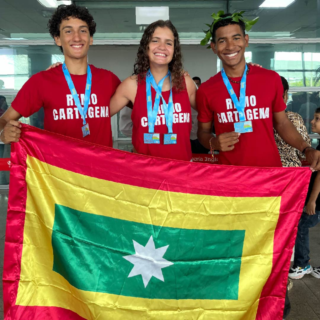 Alejandro Riccardi, Matilde Maciá and Santiago Monsalve with medals from the Copa America Coastal 2026.