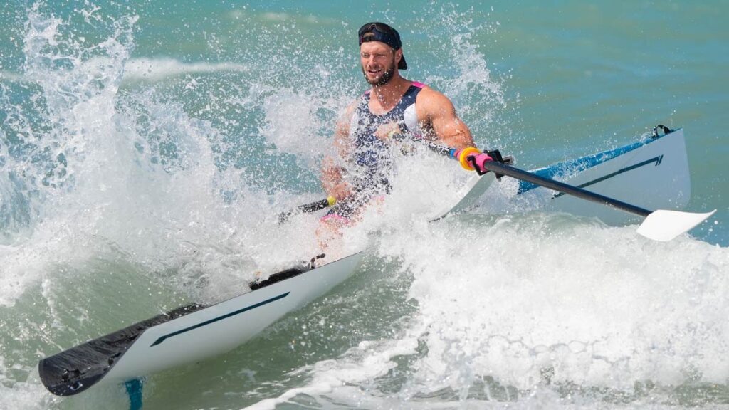 Chris Bak launches into breaking waves