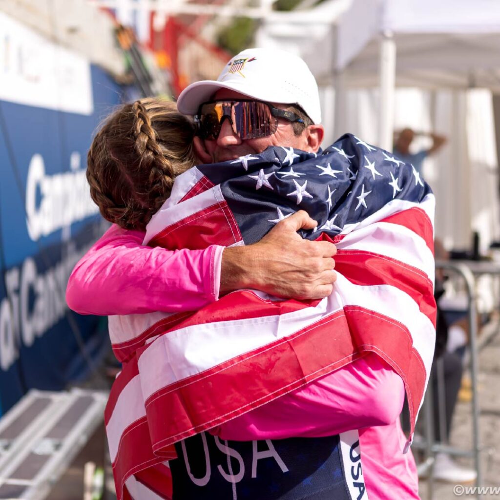 Marc Oria embraces Annelise Hahl after she wins the under-19 women's solo at 2024 worlds.