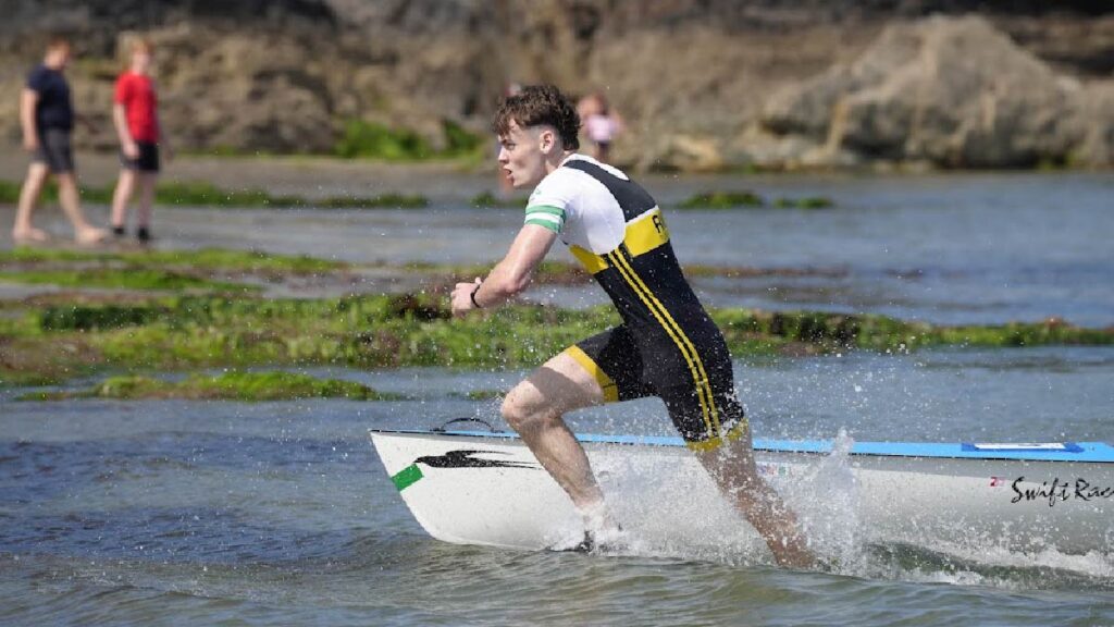 Connor Kelly runs through the shallows on his way to the finish line.