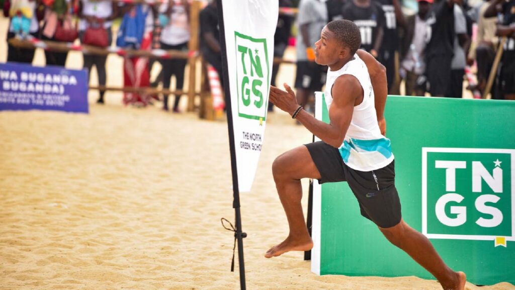 Kampala Rowing Club's Derrick Muhindo races around a flag in front of the crowd at the Buganda Royal Regatta.