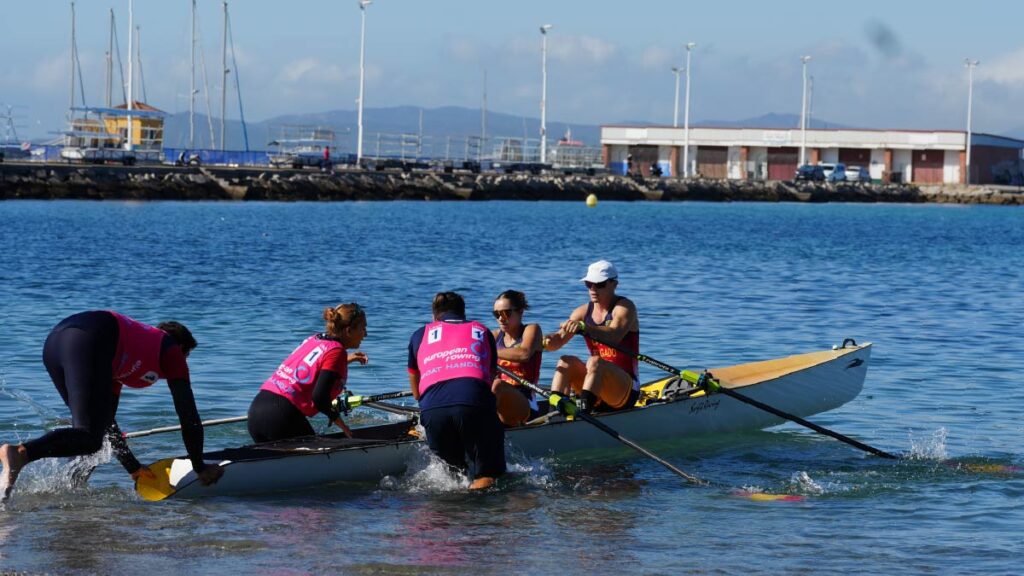 Spain's boat handlers launch Rocio Fraguela and Marcos Delgado off the beach in the inclusion mixed double.