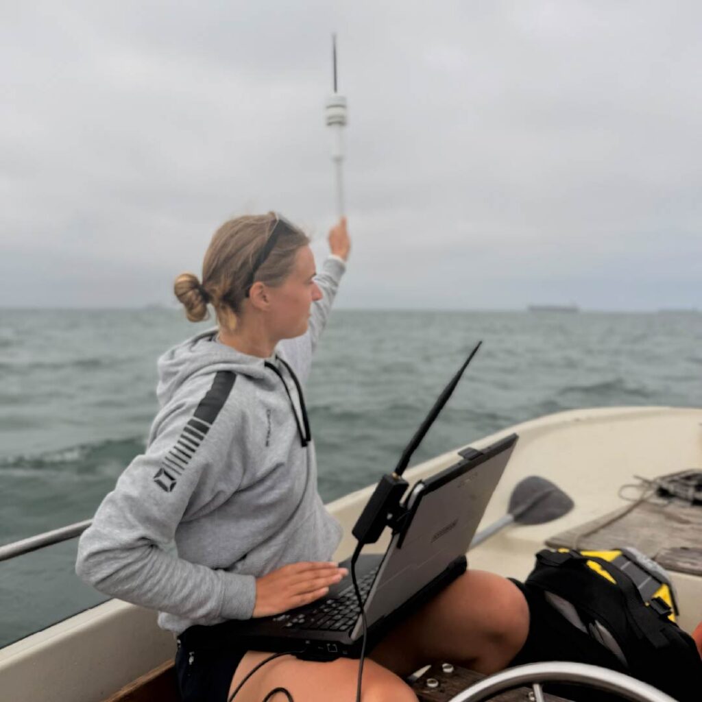 Biomechanist Amber Bittscheidt collects data during a training session on the water