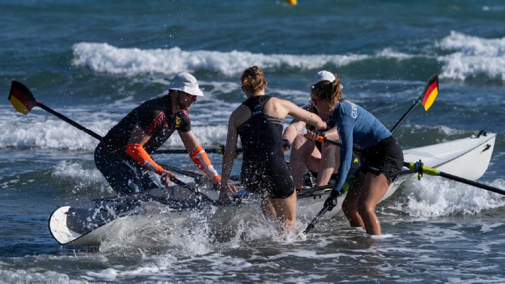 Germany's Julia Tertuente jumps in the boat with Franz Werner