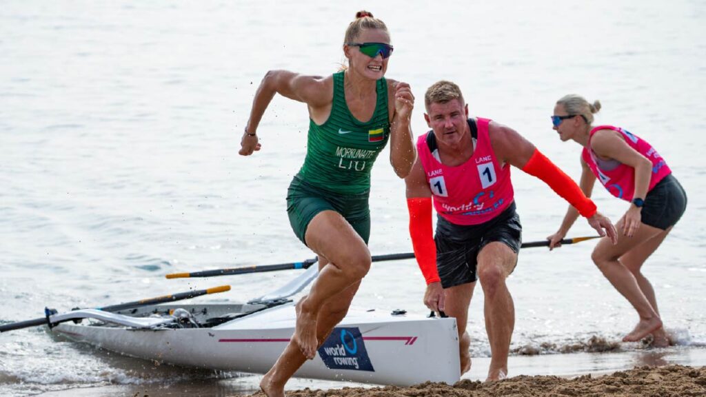 Raminta Morkunaite sprints up the beach while Vygantas Virsilas catches her boat