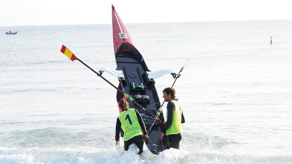 Spanish coaches attempt to get water out of one the solos at the first round of this year's Filippi Trophy