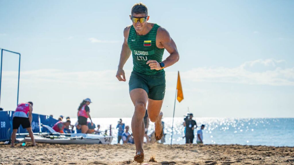 Zygimantas Galisanskis runs towards the finish line at the 2025 World Rowing Beach Sprint Finals